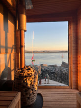 Load image into Gallery viewer, The inside of our Wood Burning Sauna, with a window with a view out over the sea at Rosses Point Yacht Club
